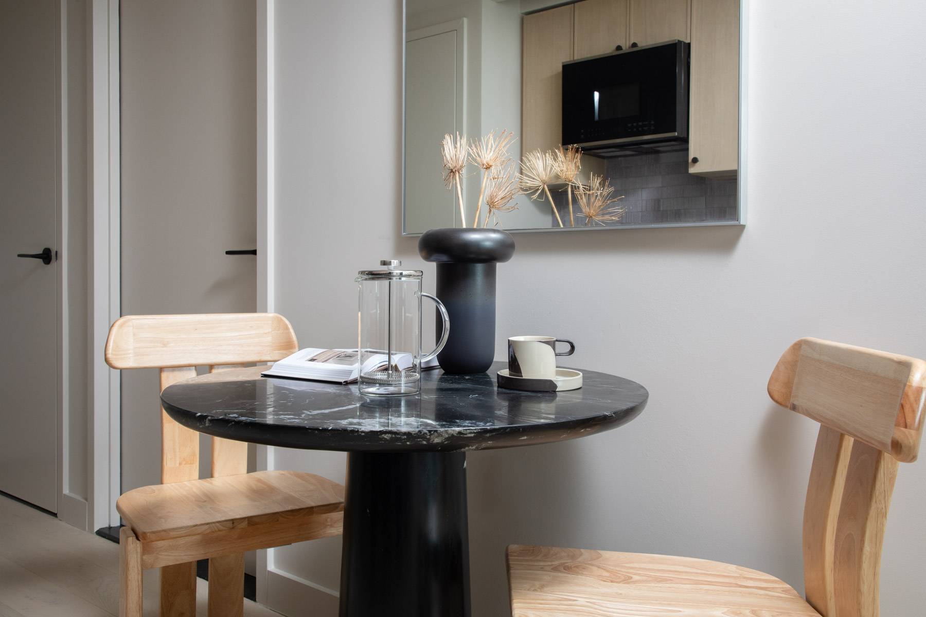 Round dining table with two wood chairs